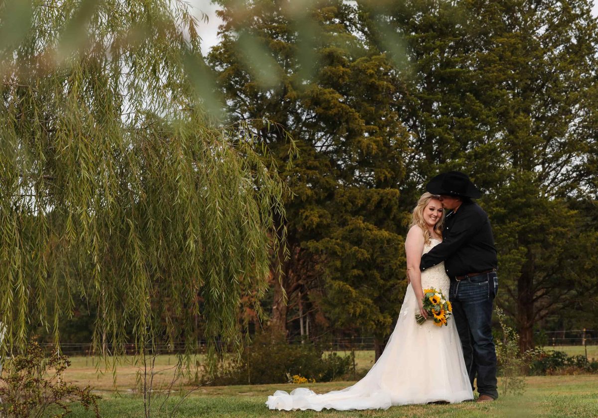 Bride and groom by willow tree at Snow Hill, MD wedding venue