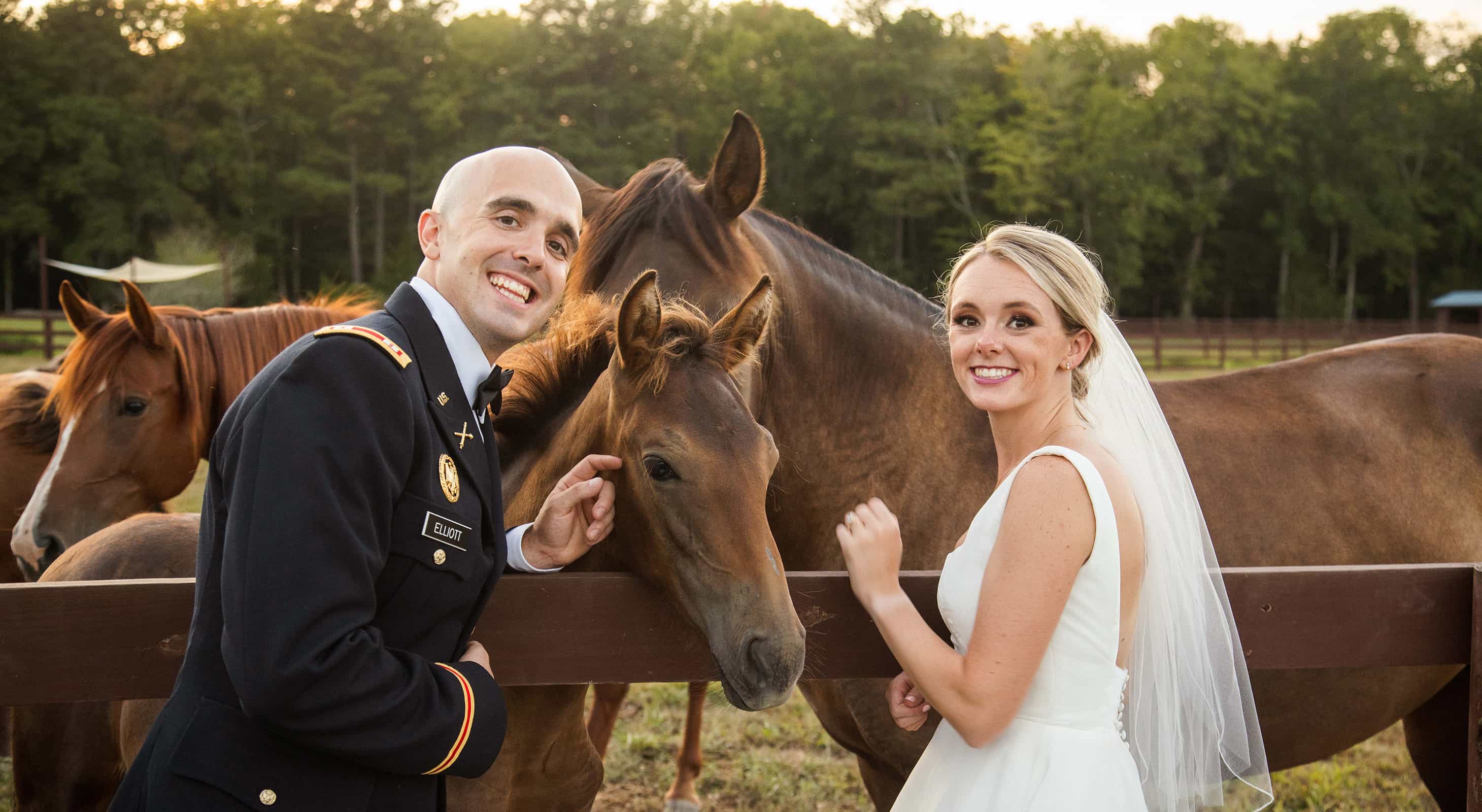 Bride and groom petting horses at luxury equestrian wedding estate in Maryland